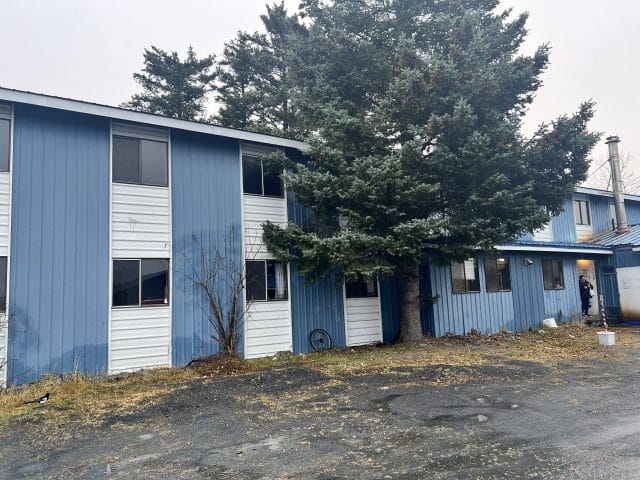 Blue building with trees in front